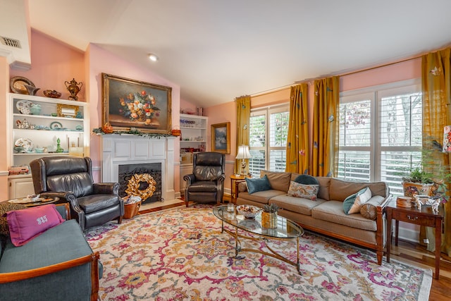 living room featuring hardwood / wood-style flooring and lofted ceiling