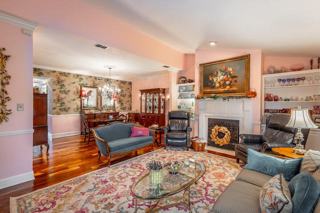 living room with hardwood / wood-style flooring, a chandelier, crown molding, and lofted ceiling