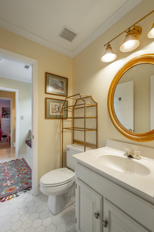 bathroom featuring toilet, vanity, tile patterned flooring, and ornamental molding