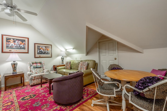 living room featuring lofted ceiling, ceiling fan, and wood-type flooring