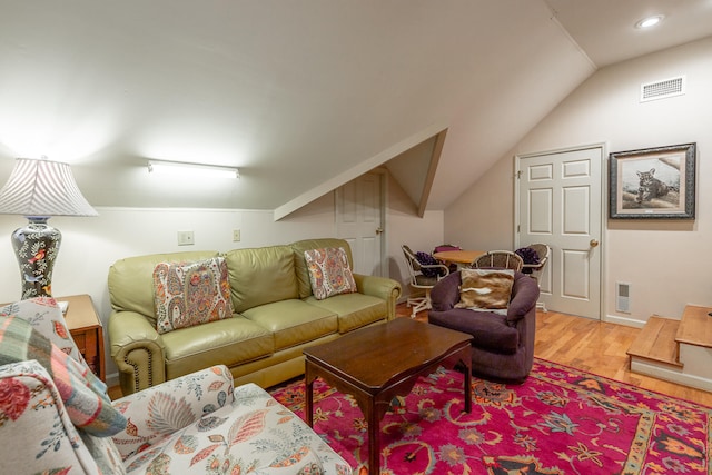 living room featuring hardwood / wood-style floors and vaulted ceiling