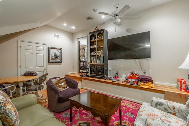 living room with ceiling fan, lofted ceiling, and wood-type flooring