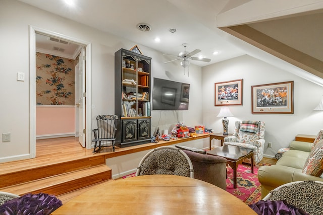 living room featuring wood-type flooring and ceiling fan