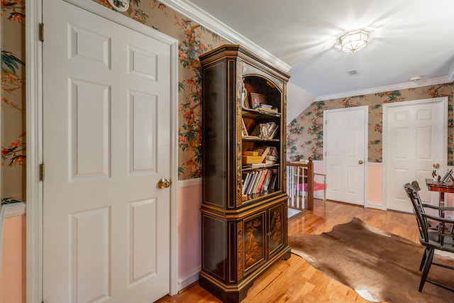 hallway featuring hardwood / wood-style flooring and crown molding