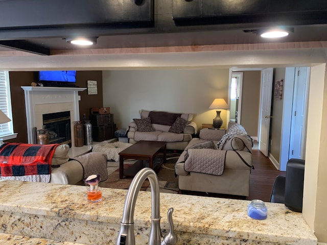 living room featuring plenty of natural light, hardwood / wood-style flooring, and beam ceiling