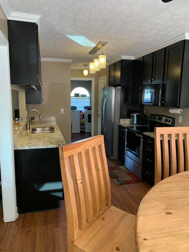 kitchen with sink, dark hardwood / wood-style floors, crown molding, pendant lighting, and appliances with stainless steel finishes