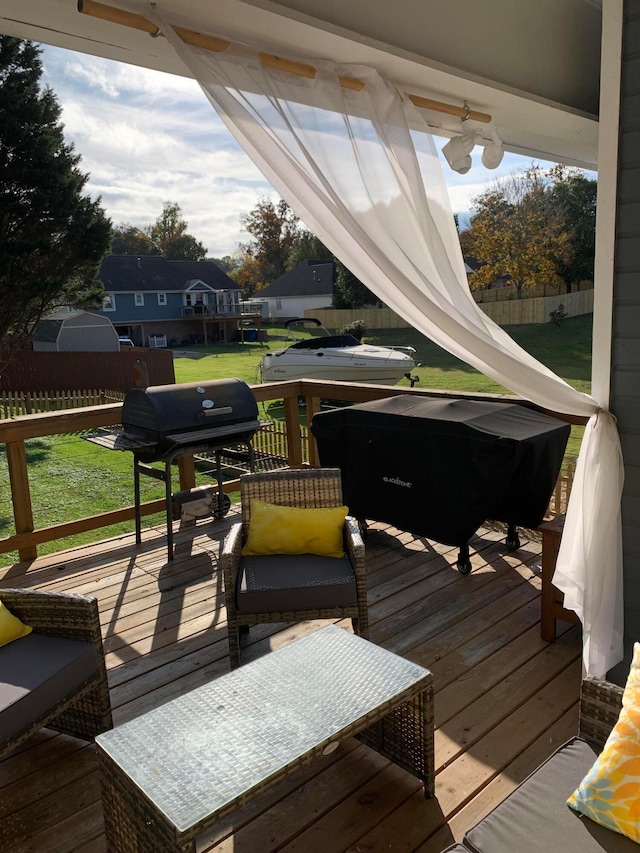 deck with a lawn and ceiling fan