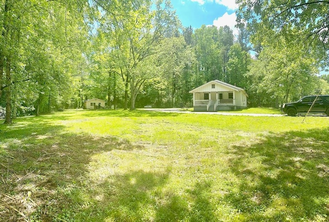 view of yard featuring covered porch