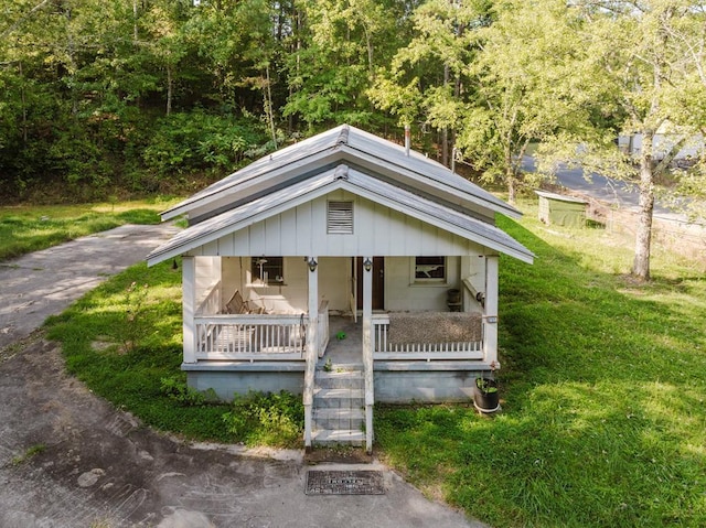 bungalow-style house with covered porch and a front lawn