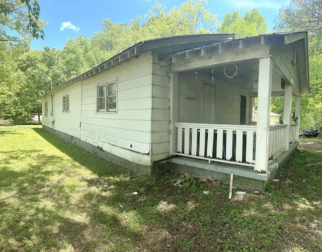 view of side of home with a lawn