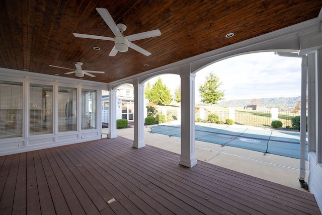 wooden terrace with a patio area, ceiling fan, and a covered pool