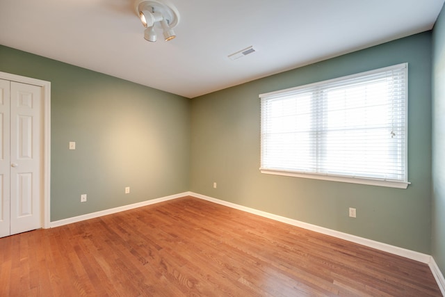 spare room with light wood-type flooring