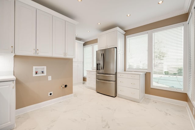 kitchen featuring white cabinetry, stainless steel fridge with ice dispenser, and ornamental molding