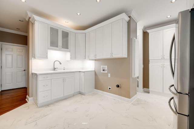 clothes washing area with cabinets, washer hookup, hookup for an electric dryer, crown molding, and sink