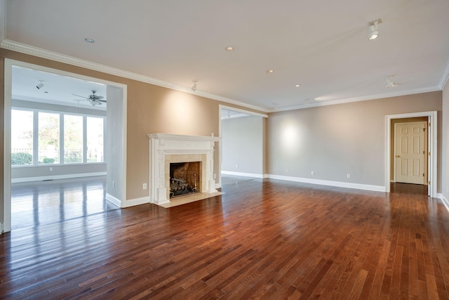 unfurnished living room with dark hardwood / wood-style flooring, a fireplace, and ornamental molding