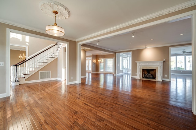 unfurnished living room featuring wood-type flooring, ceiling fan, ornamental molding, and a premium fireplace