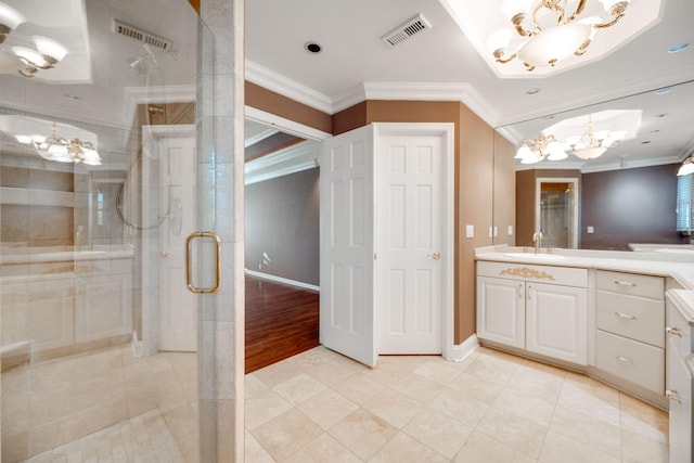 bathroom featuring ornamental molding, vanity, an inviting chandelier, tile patterned flooring, and a shower with shower door