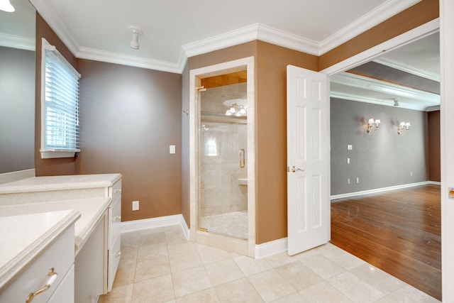 bathroom featuring tile patterned floors, a shower with door, and ornamental molding