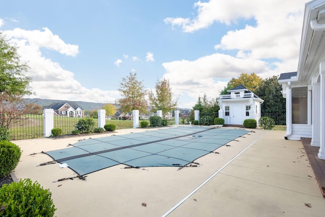 view of pool featuring an outbuilding and a patio