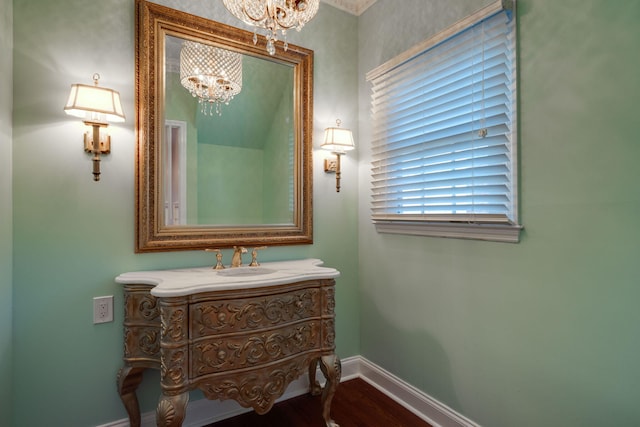 bathroom featuring hardwood / wood-style floors, a notable chandelier, and vanity