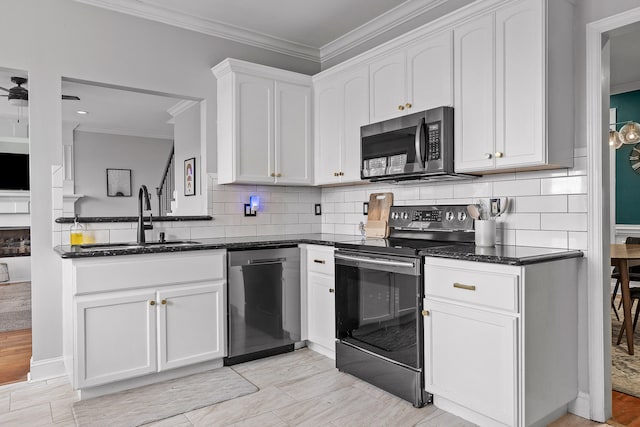 kitchen with white cabinetry, sink, appliances with stainless steel finishes, and crown molding