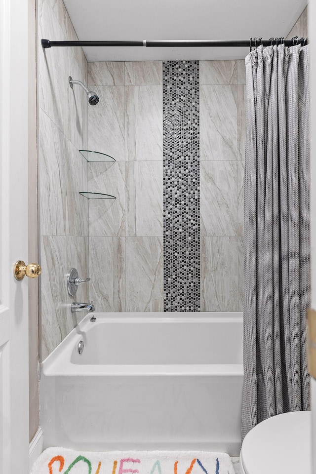 bathroom featuring shower / bath combo and toilet