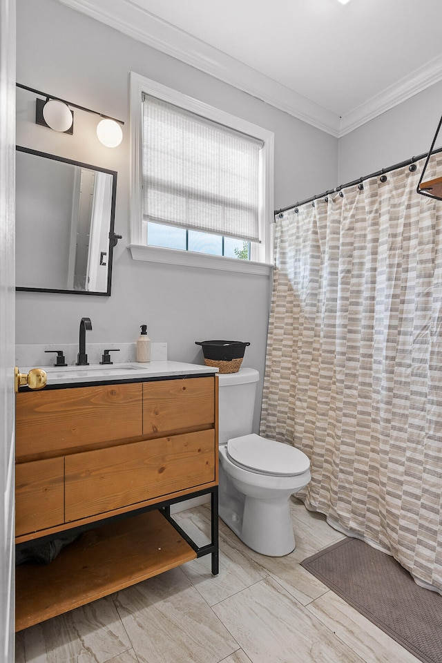 bathroom with walk in shower, vanity, toilet, and ornamental molding