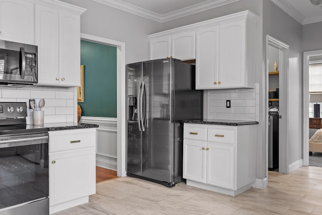 kitchen with white cabinetry, stainless steel appliances, and crown molding