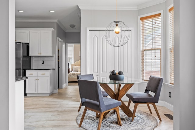 dining room featuring ornamental molding