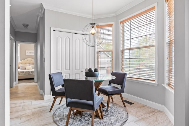 dining room with a chandelier and ornamental molding