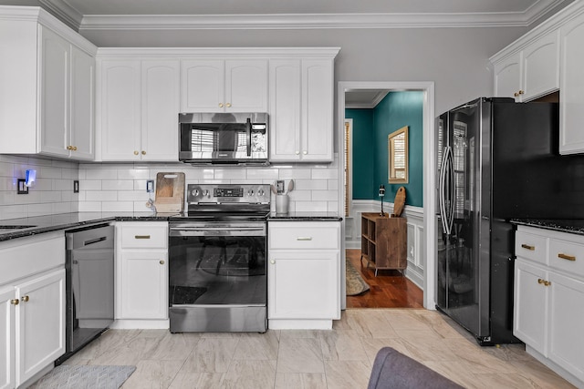 kitchen featuring decorative backsplash, black appliances, crown molding, white cabinetry, and dark stone countertops