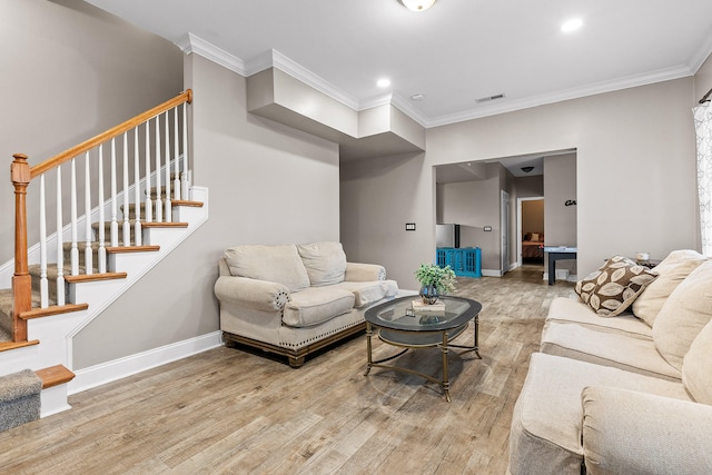 living room with hardwood / wood-style flooring and crown molding