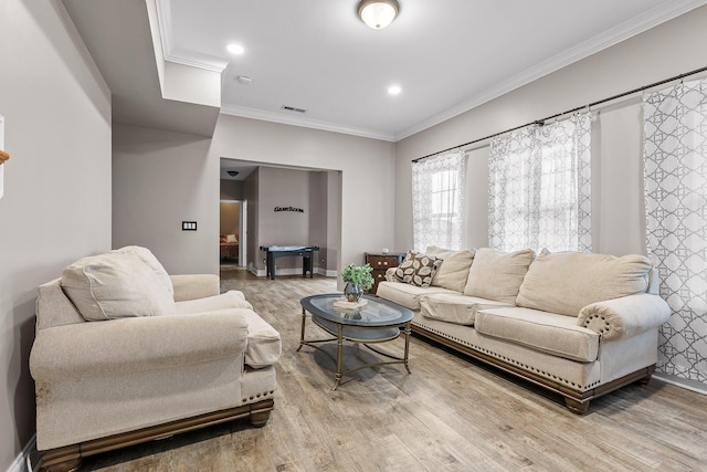 living room featuring ornamental molding and hardwood / wood-style floors