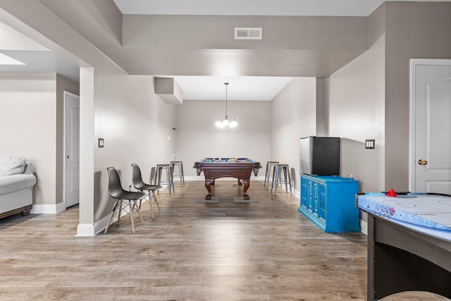 playroom featuring an inviting chandelier, pool table, and light wood-type flooring