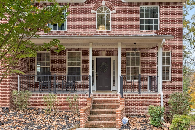 property entrance featuring covered porch