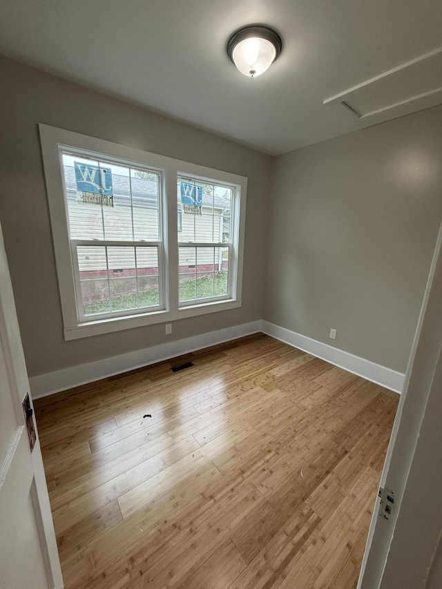 unfurnished room with a healthy amount of sunlight and light wood-type flooring