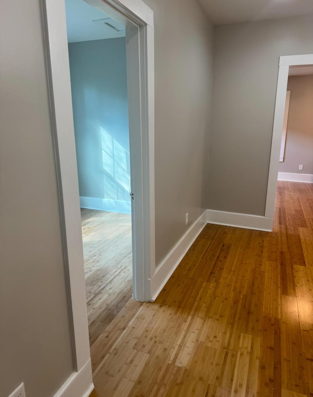 hallway with light hardwood / wood-style flooring