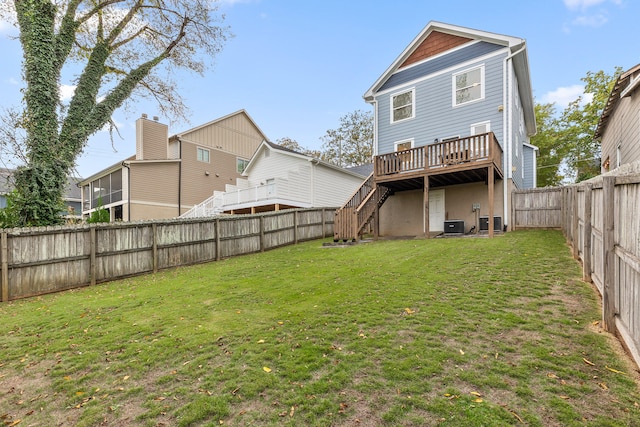 rear view of house with central air condition unit, a lawn, and a deck