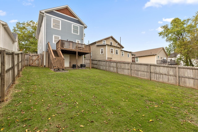 back of house featuring central air condition unit, a lawn, and a wooden deck