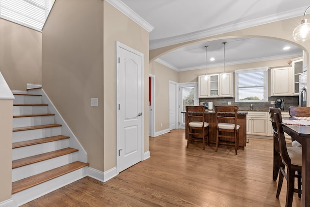 dining room featuring ornamental molding and light hardwood / wood-style flooring