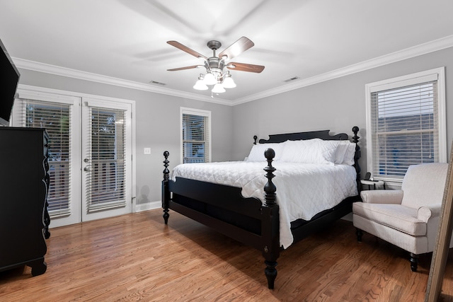 bedroom with ceiling fan, access to exterior, hardwood / wood-style floors, crown molding, and french doors