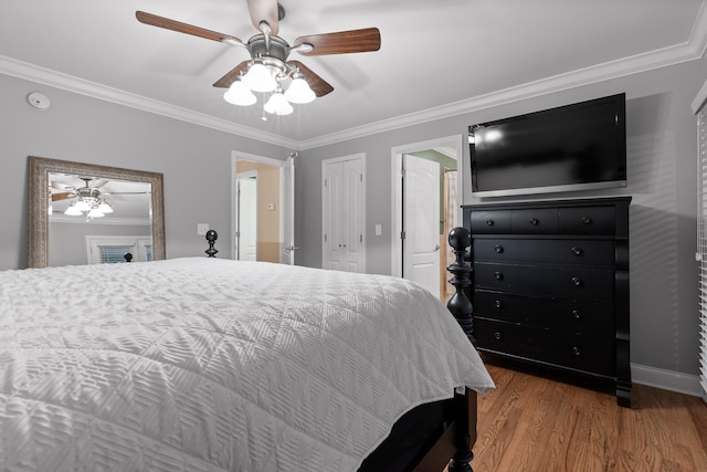 bedroom featuring hardwood / wood-style floors, ceiling fan, and crown molding