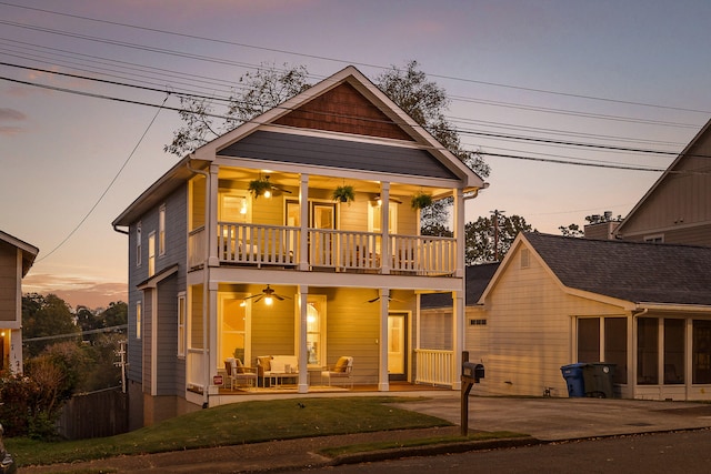 view of front of property with a patio, outdoor lounge area, ceiling fan, and a balcony