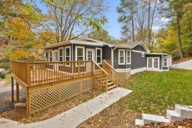 view of front of house featuring a front lawn and a deck