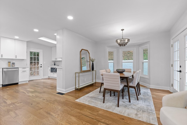 dining room featuring a chandelier and light hardwood / wood-style flooring