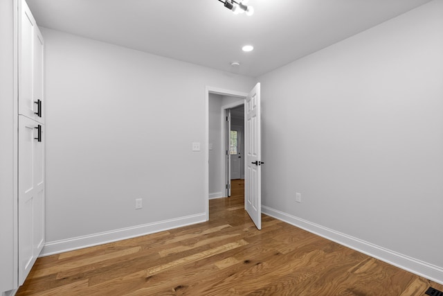 empty room featuring hardwood / wood-style flooring