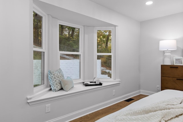 bedroom with dark wood-type flooring