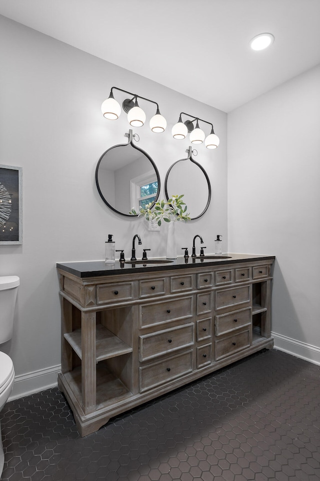 bathroom featuring vanity and toilet