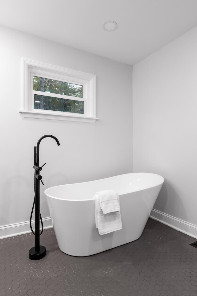 bathroom featuring a bath and tile patterned floors