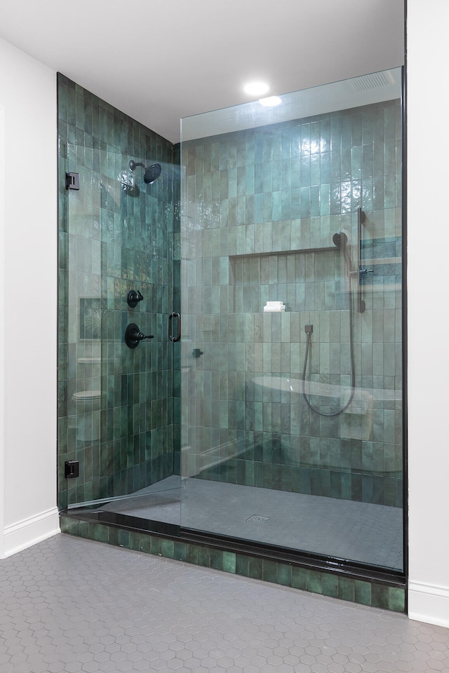 bathroom featuring walk in shower and tile patterned flooring